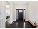 Inviting foyer boasts dark hardwood floors and a stylish front door with decorative glass panels and transom window at 3037 Freeman Farm Way, Rolesville, NC 27571