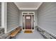 Inviting front door with stone accents and welcome mat at 3037 Freeman Farm Way, Rolesville, NC 27571