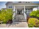 Inviting front porch with stone stairs and columns, leading to the front door of the two-story home at 3037 Freeman Farm Way, Rolesville, NC 27571