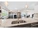 Open-concept kitchen flows into the living room, showcasing a breakfast bar and elegant design elements at 3037 Freeman Farm Way, Rolesville, NC 27571