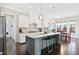 Modern kitchen features a large center island with marble countertops and barstool seating at 3037 Freeman Farm Way, Rolesville, NC 27571