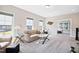 Inviting living room with ample natural light, a comfortable sofa, and views of the backyard through large windows at 3037 Freeman Farm Way, Rolesville, NC 27571
