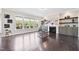 Inviting living room features hardwood floors, built-in shelving, fireplace, and large windows with a view to the backyard at 3037 Freeman Farm Way, Rolesville, NC 27571