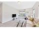 Spacious living area with a comfortable sofa, a window seat, and a modern glass coffee table on soft carpet at 3037 Freeman Farm Way, Rolesville, NC 27571