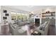Staged living room with a comfortable seating arrangement, a fireplace, and large windows with backyard views at 3037 Freeman Farm Way, Rolesville, NC 27571