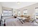 Cozy living room featuring plush seating, a large window seat, and a glass-topped coffee table on neutral carpet at 3037 Freeman Farm Way, Rolesville, NC 27571