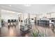 Open-concept living space with a modern kitchen, dining area, and dark hardwood flooring at 3037 Freeman Farm Way, Rolesville, NC 27571