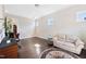 Bright office space with hardwood floors, a comfortable sofa, and a desk with natural light from multiple windows at 3037 Freeman Farm Way, Rolesville, NC 27571