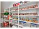 Organized pantry with white shelving and storage containers for dry goods, snacks, and kitchen staples at 3037 Freeman Farm Way, Rolesville, NC 27571