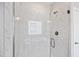 Modern glass shower featuring marbled walls and chrome hardware at 3037 Freeman Farm Way, Rolesville, NC 27571