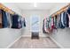 Spacious walk-in closet offers ample storage with custom shelving and a central window for natural light at 3037 Freeman Farm Way, Rolesville, NC 27571