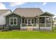 A fenced backyard with green grass and a covered deck is perfect for outdoor living at 33 Highpointe Dr, Pittsboro, NC 27312