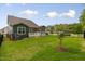 A fenced backyard with green grass and a covered deck is perfect for outdoor living at 33 Highpointe Dr, Pittsboro, NC 27312
