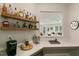 Wet bar area featuring floating shelves and a view into the living room at 33 Highpointe Dr, Pittsboro, NC 27312