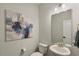 Stylish powder room with a modern sink, a stylish mirror, and a neutral color palette at 33 Highpointe Dr, Pittsboro, NC 27312