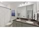 Bathroom featuring double vanity sinks and a large mirror with modern lighting at 33 Highpointe Dr, Pittsboro, NC 27312