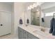 Contemporary bathroom featuring double sinks, modern lighting, and glass-enclosed shower at 33 Highpointe Dr, Pittsboro, NC 27312