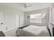 This bedroom features neutral walls, a ceiling fan, large window, and a comfortable queen-sized bed at 33 Highpointe Dr, Pittsboro, NC 27312