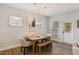 Bright dining room features modern light fixture, wood floors, and a dining table with bench seating at 33 Highpointe Dr, Pittsboro, NC 27312