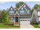 Beautiful two-story home with a manicured lawn, a two-car garage, and an inviting front porch at 33 Highpointe Dr, Pittsboro, NC 27312