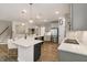 Spacious kitchen featuring quartz counters, an island with seating, and modern appliances at 33 Highpointe Dr, Pittsboro, NC 27312