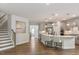 Well-lit kitchen with island seating and staircase access at 33 Highpointe Dr, Pittsboro, NC 27312