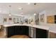 Open kitchen features an island with seating, stainless steel appliances, and a modern design at 33 Highpointe Dr, Pittsboro, NC 27312