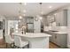 Bright kitchen features an island with seating, stainless steel appliances, and ample countertop space at 33 Highpointe Dr, Pittsboro, NC 27312