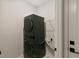 A modern, stacked washer and dryer set in a compact laundry space at 33 Highpointe Dr, Pittsboro, NC 27312
