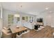 Open concept living room and dining area featuring ample natural light and hardwood floors at 33 Highpointe Dr, Pittsboro, NC 27312
