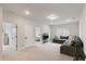 Spacious living room featuring a gray sofa, recessed lighting, and neutral carpet at 33 Highpointe Dr, Pittsboro, NC 27312
