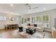 Open-concept living area with natural light, stylish furnishings, and wood flooring at 33 Highpointe Dr, Pittsboro, NC 27312