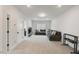 Spacious living room featuring a gray sofa, recessed lighting, and neutral carpet at 33 Highpointe Dr, Pittsboro, NC 27312