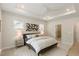 Comfortable main bedroom with tray ceilings, ceiling fan, and ample natural light from windows at 33 Highpointe Dr, Pittsboro, NC 27312