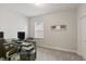 Bright office space with neutral walls and carpet, featuring a modern desk setup at 33 Highpointe Dr, Pittsboro, NC 27312