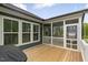 Screened in porch with wood flooring allows nature to be viewed without the annoyance of bugs at 33 Highpointe Dr, Pittsboro, NC 27312