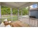 A screened in porch with wood flooring allows nature to be viewed without the annoyance of bugs at 33 Highpointe Dr, Pittsboro, NC 27312