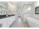 Luxurious bathroom with double vanities, a soaking tub, a glass-enclosed shower, and stylish tile flooring at 3545 Donlin Dr, Wake Forest, NC 27587