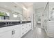 Elegant bathroom featuring double sinks, modern fixtures, a glass-enclosed shower, and patterned tile floors at 3545 Donlin Dr, Wake Forest, NC 27587