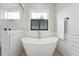 Bright bathroom features a soaking tub with shiplap accent wall, and a window at 3545 Donlin Dr, Wake Forest, NC 27587