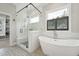 Bright bathroom featuring a soaking tub, glass shower, and decorative tile flooring at 3545 Donlin Dr, Wake Forest, NC 27587