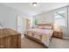 Cozy bedroom with natural light offers a comfy bed and decorative wall art at 3545 Donlin Dr, Wake Forest, NC 27587