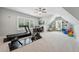 Spacious bonus room features exercise equipment, a desk and built-in shelving at 3545 Donlin Dr, Wake Forest, NC 27587