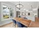 Dining room features wood table, blue chairs, and a view to the backyard at 3545 Donlin Dr, Wake Forest, NC 27587
