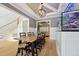 Open-concept dining area showcasing the staircase, a wooden dining table, and a built-in aquarium at 3545 Donlin Dr, Wake Forest, NC 27587