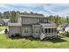Exterior shot showing a backyard, screened-in porch, and gray siding at 3545 Donlin Dr, Wake Forest, NC 27587