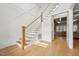 Bright entryway featuring hardwood floors, staircase with white railing, and decorative wall paneling at 3545 Donlin Dr, Wake Forest, NC 27587