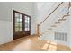 Grand entryway with hardwood floors, a staircase with white railing, and dark wood double front doors at 3545 Donlin Dr, Wake Forest, NC 27587