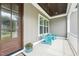 Cozy front porch with stylish seating, decorative plants, and charming architectural details at 3545 Donlin Dr, Wake Forest, NC 27587