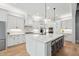 Spacious white kitchen features an island with seating, modern appliances, and ample counter space at 3545 Donlin Dr, Wake Forest, NC 27587